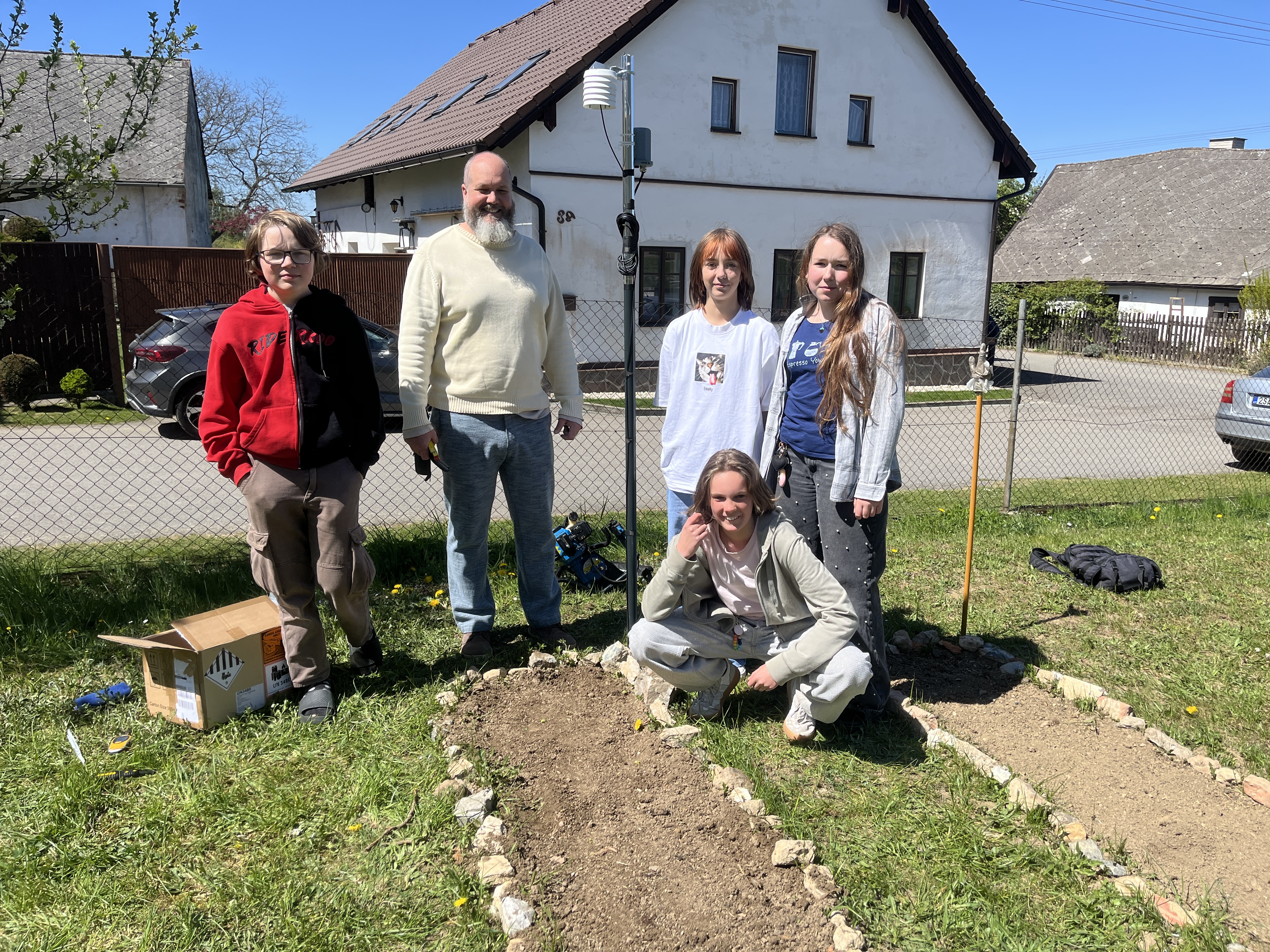 Students and teacher installing the weather station