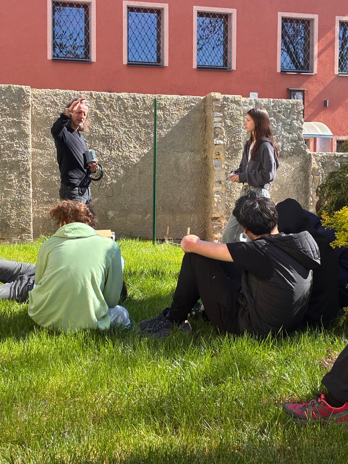 Teacher presenting the experiment to students outdoors